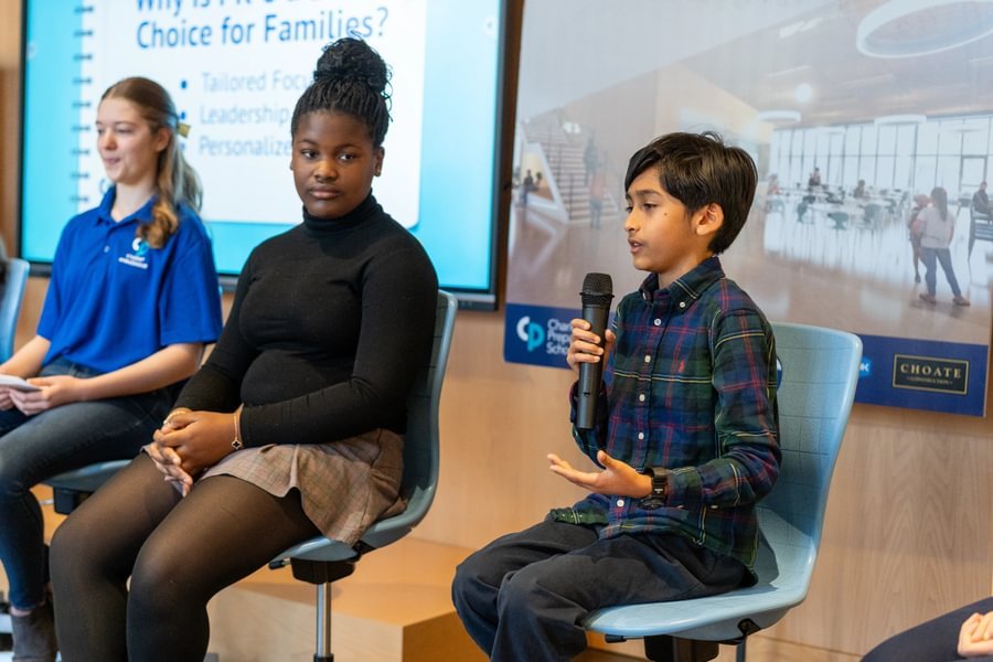 Student speaking with microphone.
