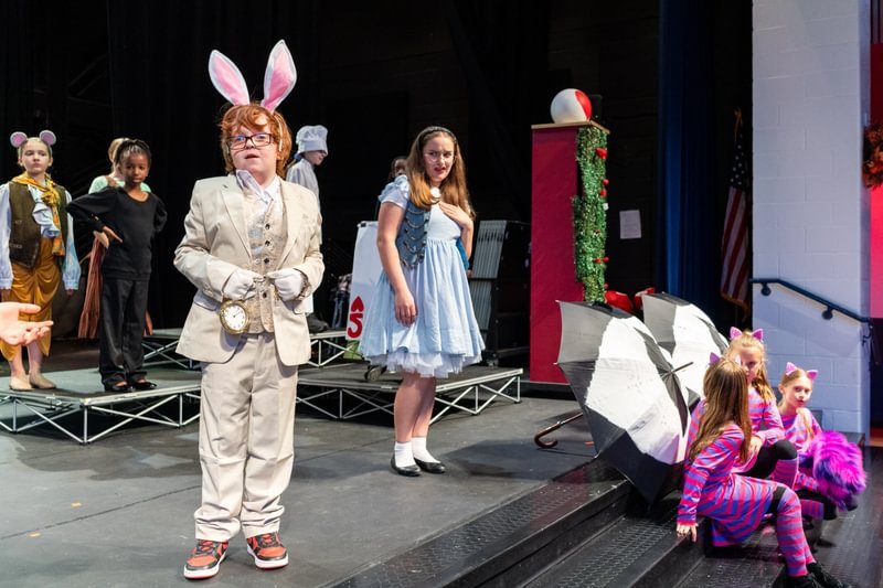 Students perform a play in costume.