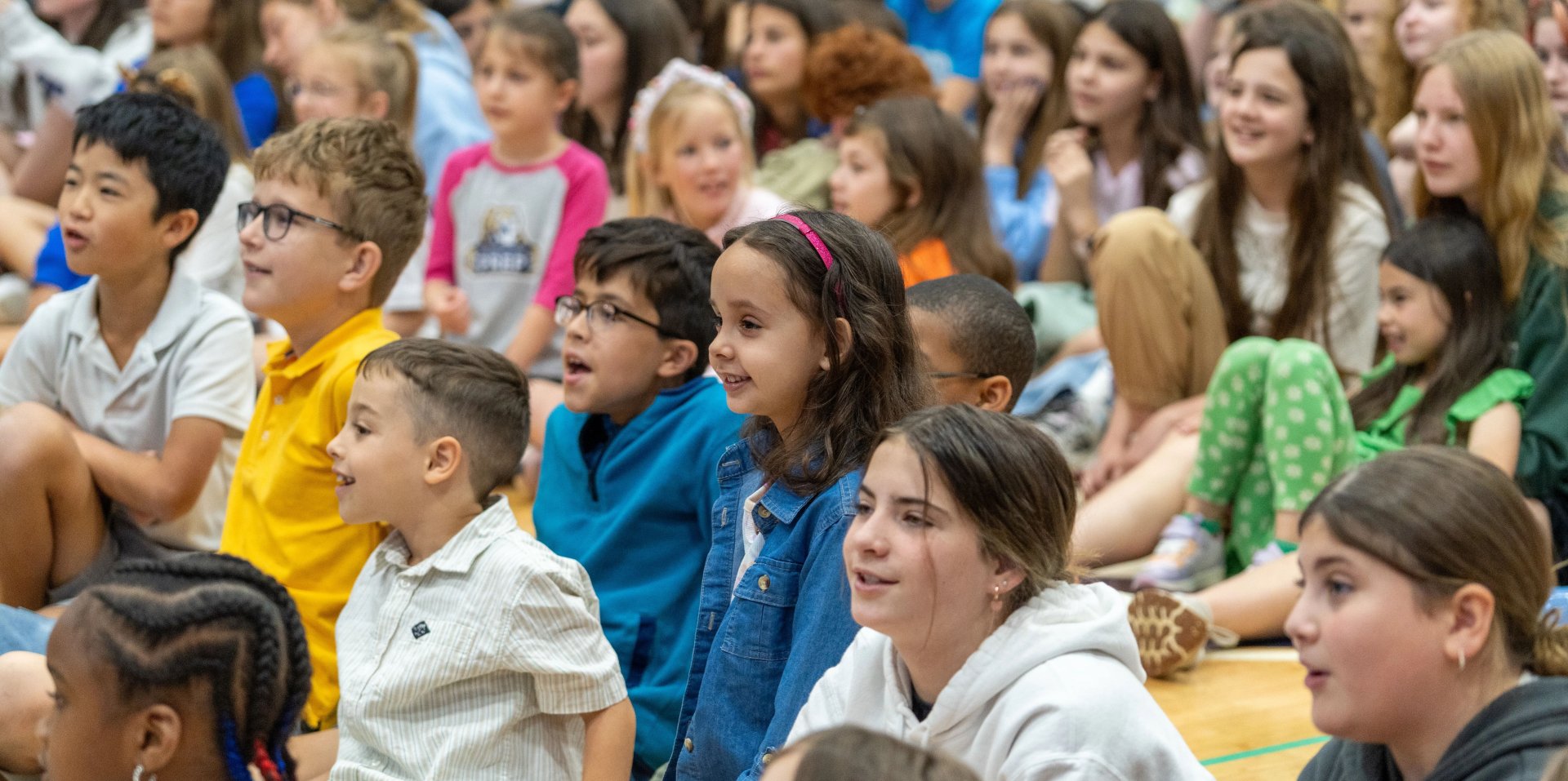 Several students sit together and smile.