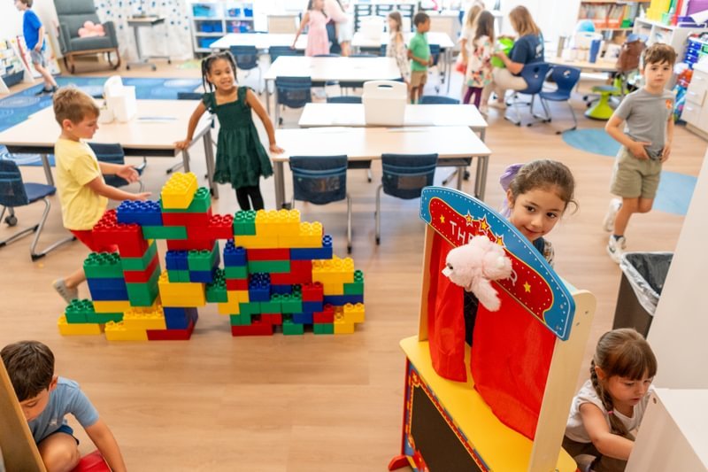 Several students gather around colorful displays.