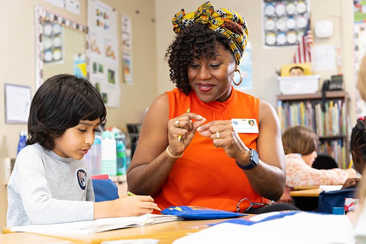 A teacher engages with a young student