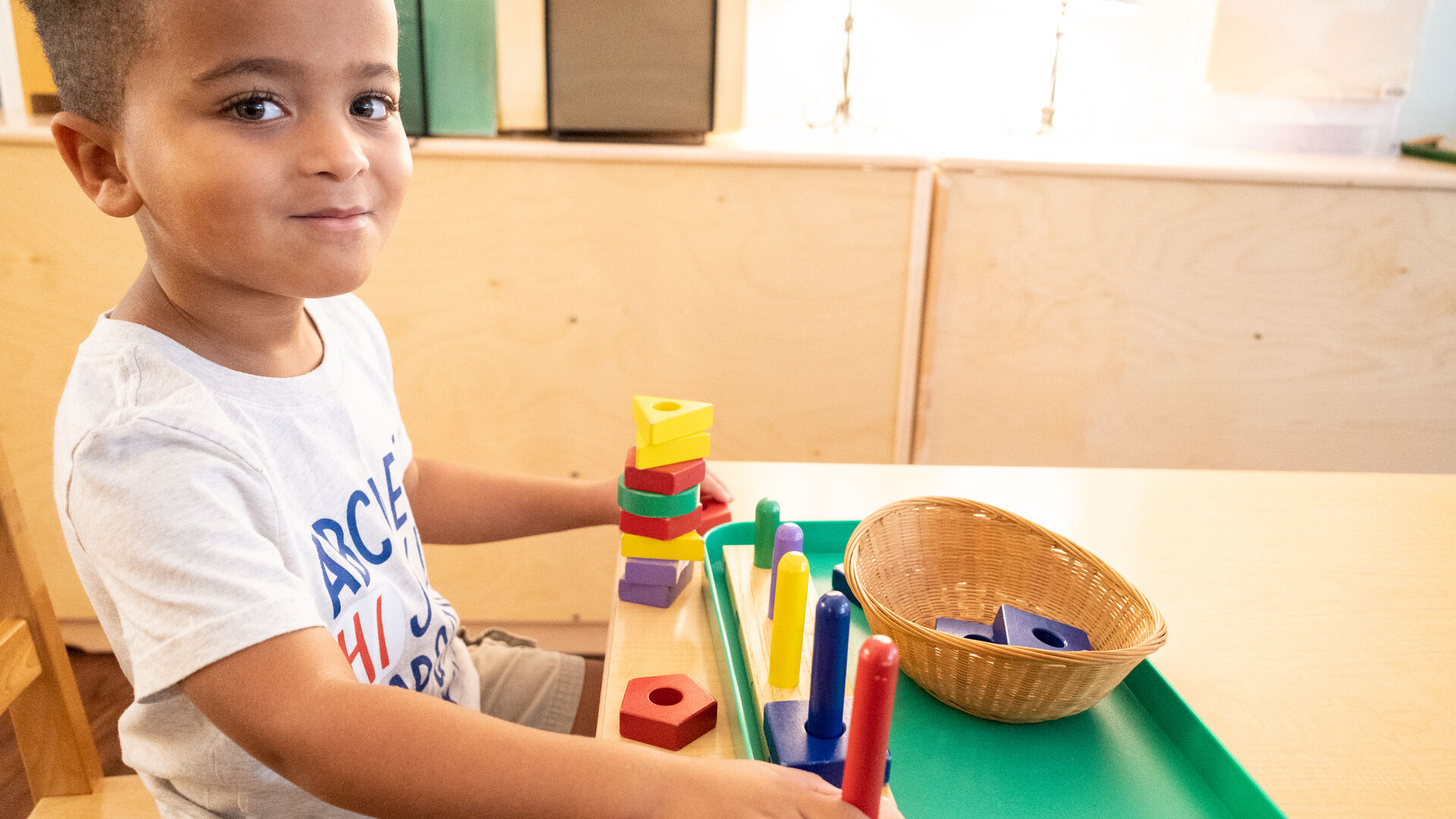A boy sorts wooden blocks