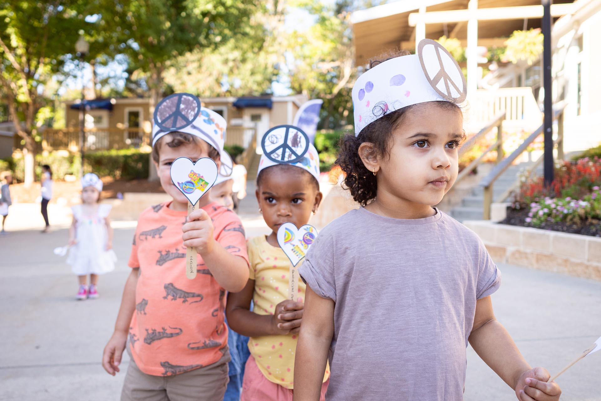 Small children wearing peace crowns