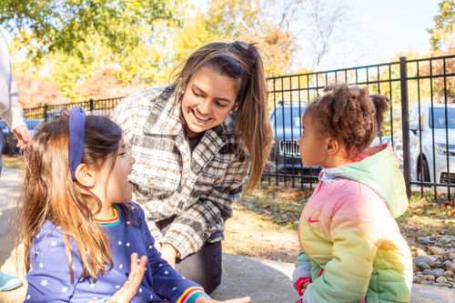A teacher plays with a student in the playground