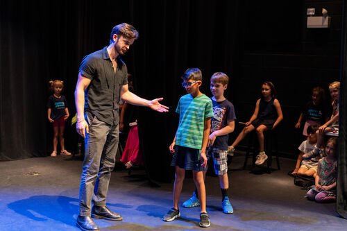 Students acting on stage