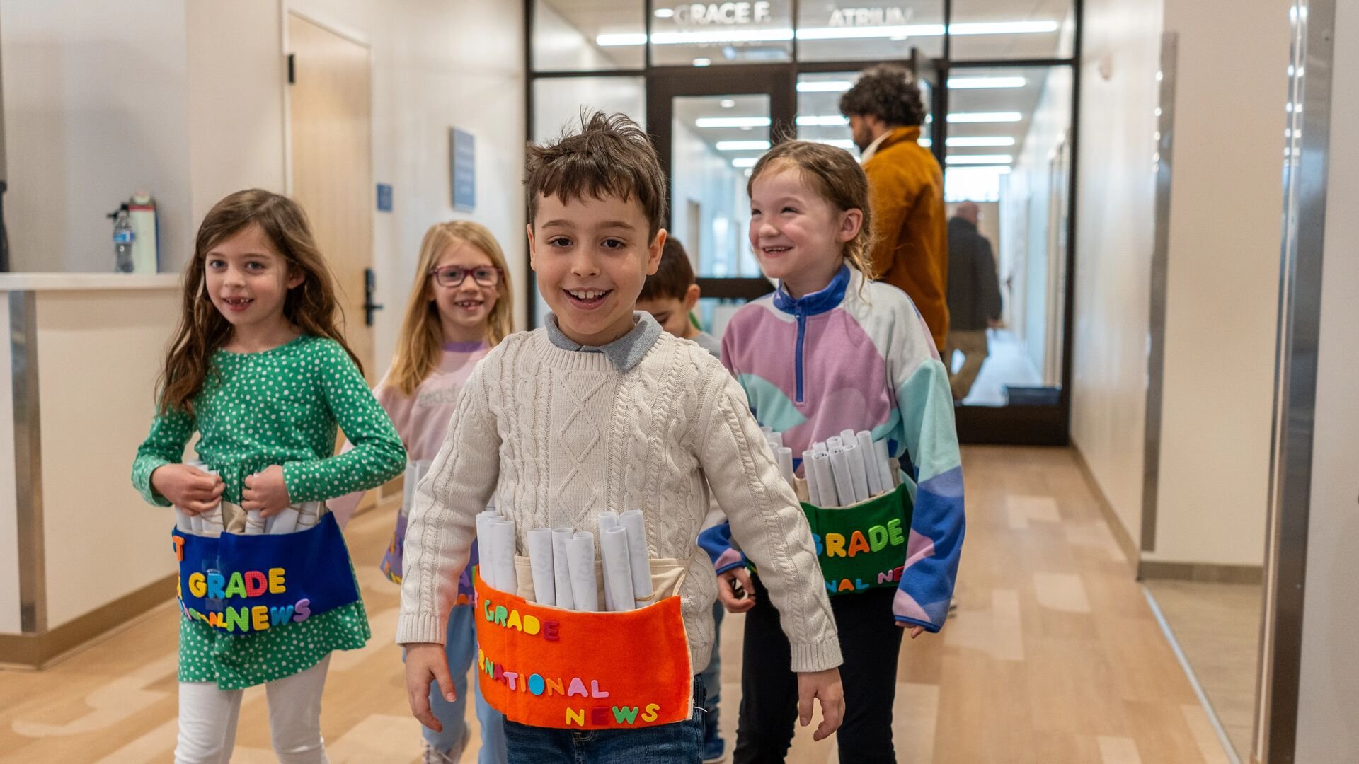 Students wear aprons to hold their newspapers
