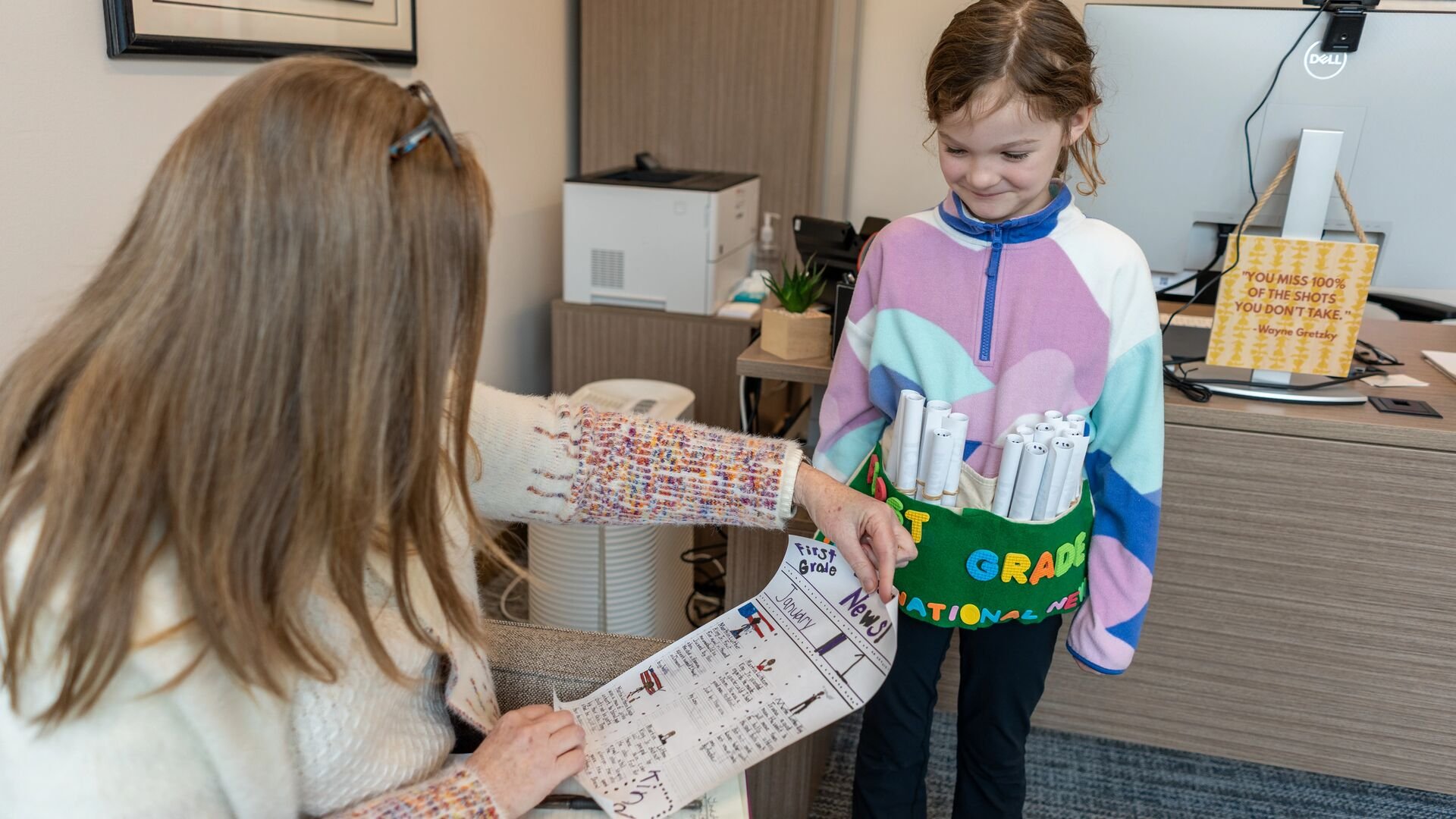 Teacher reading student's newspaper
