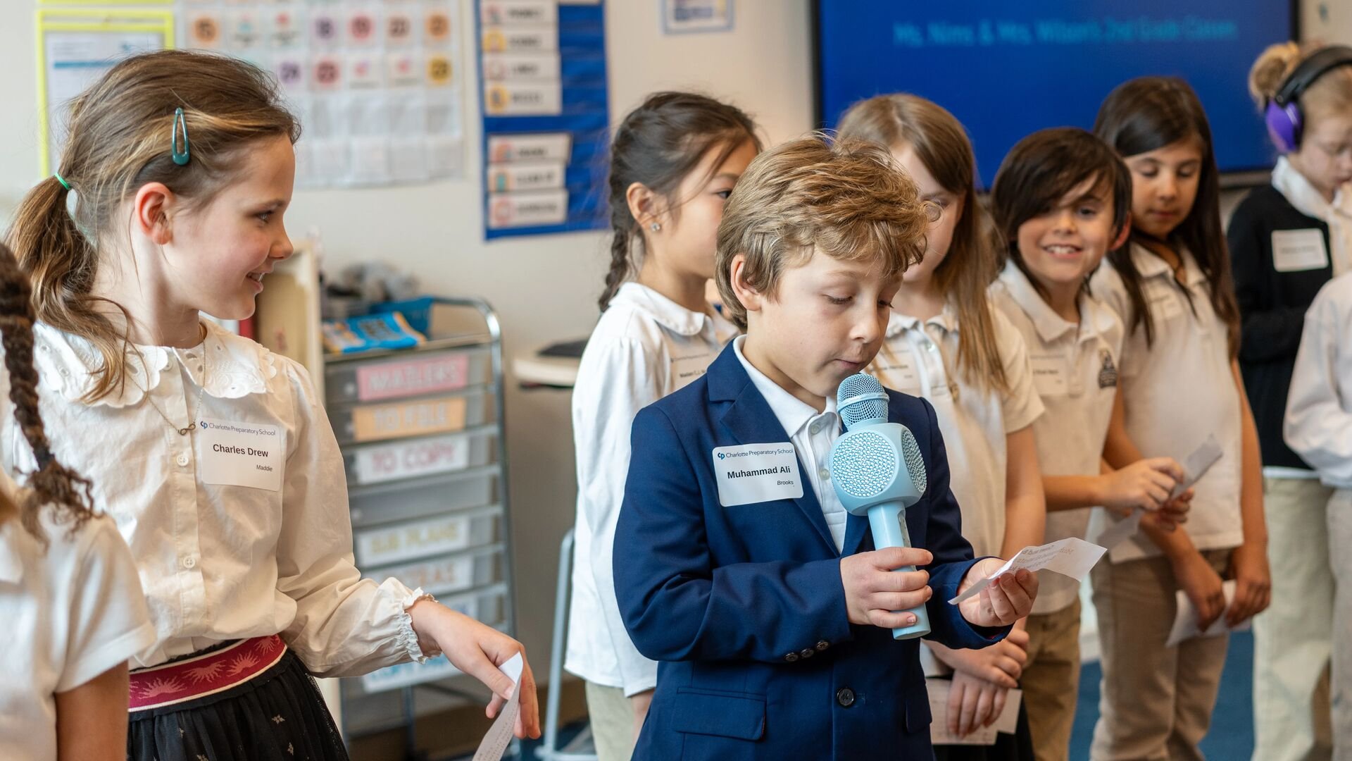 Students speaking into a microphone