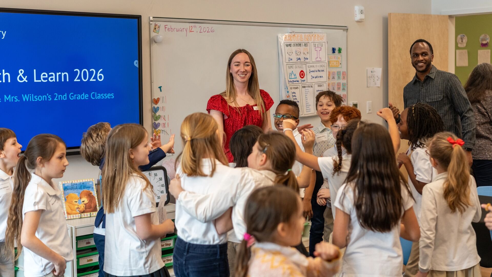 students dance with excitement after finishing their projects