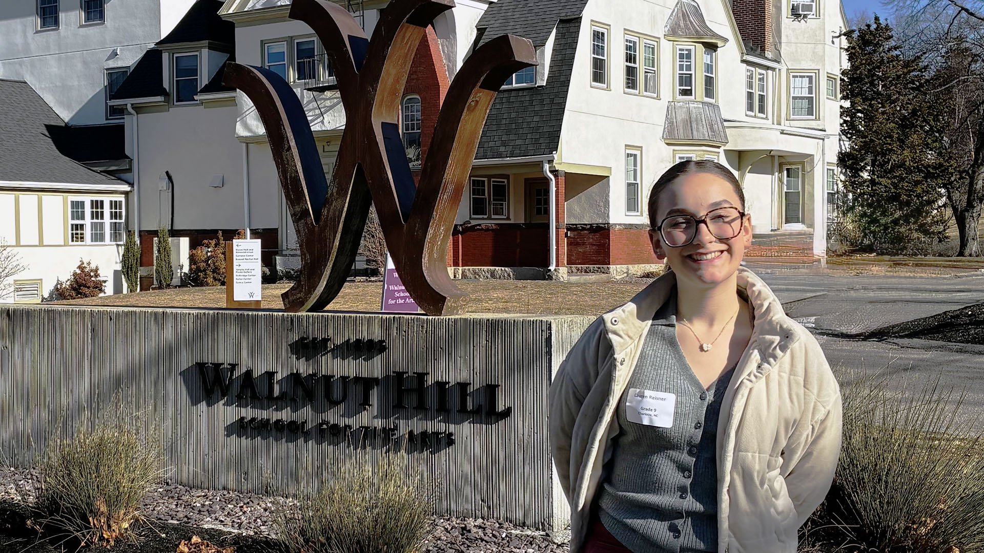 Lauren stands outside on Walnut Hill's campus