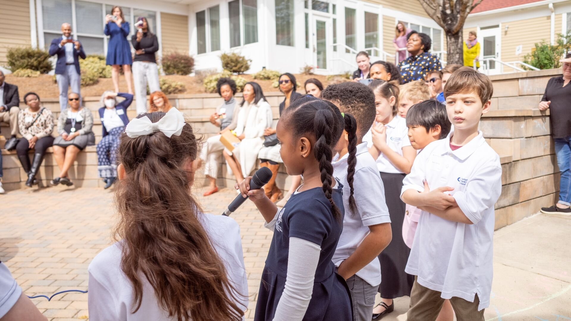 Students outside speaking into a microphone